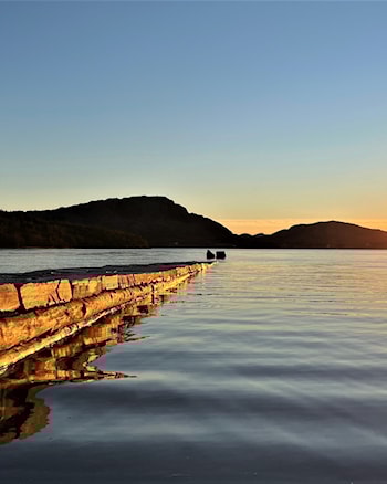 The stone jetty extends 65 metres from the beach .